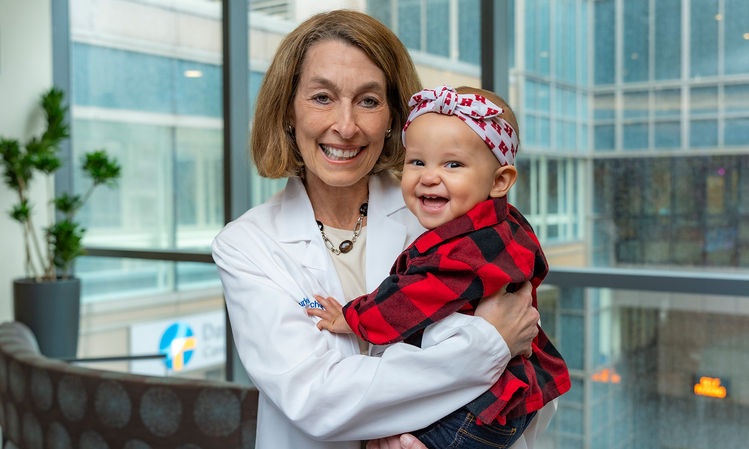 Dr. Glimcher holding a pediatric patient